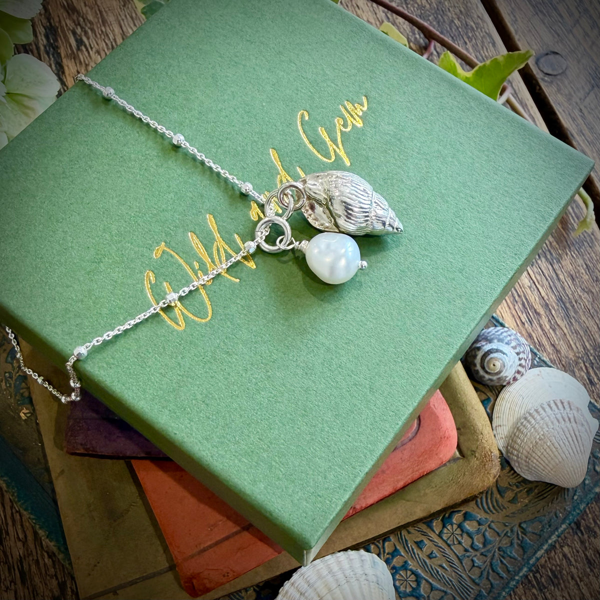 Solid silver whelk shell with keishi pearl