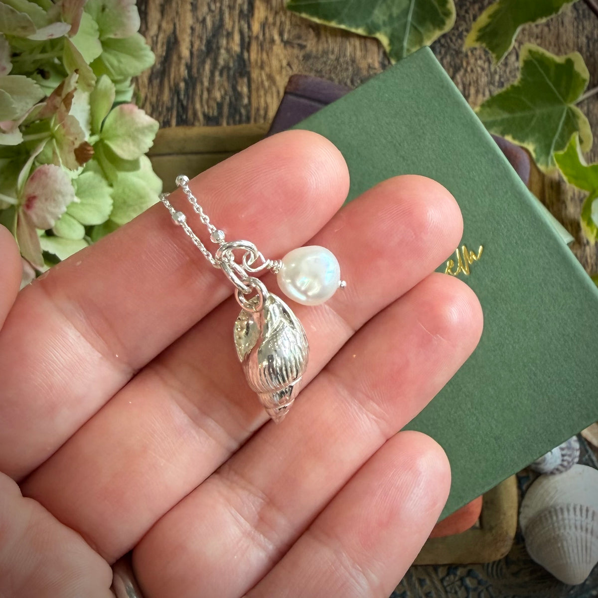 Solid silver whelk shell with keishi pearl