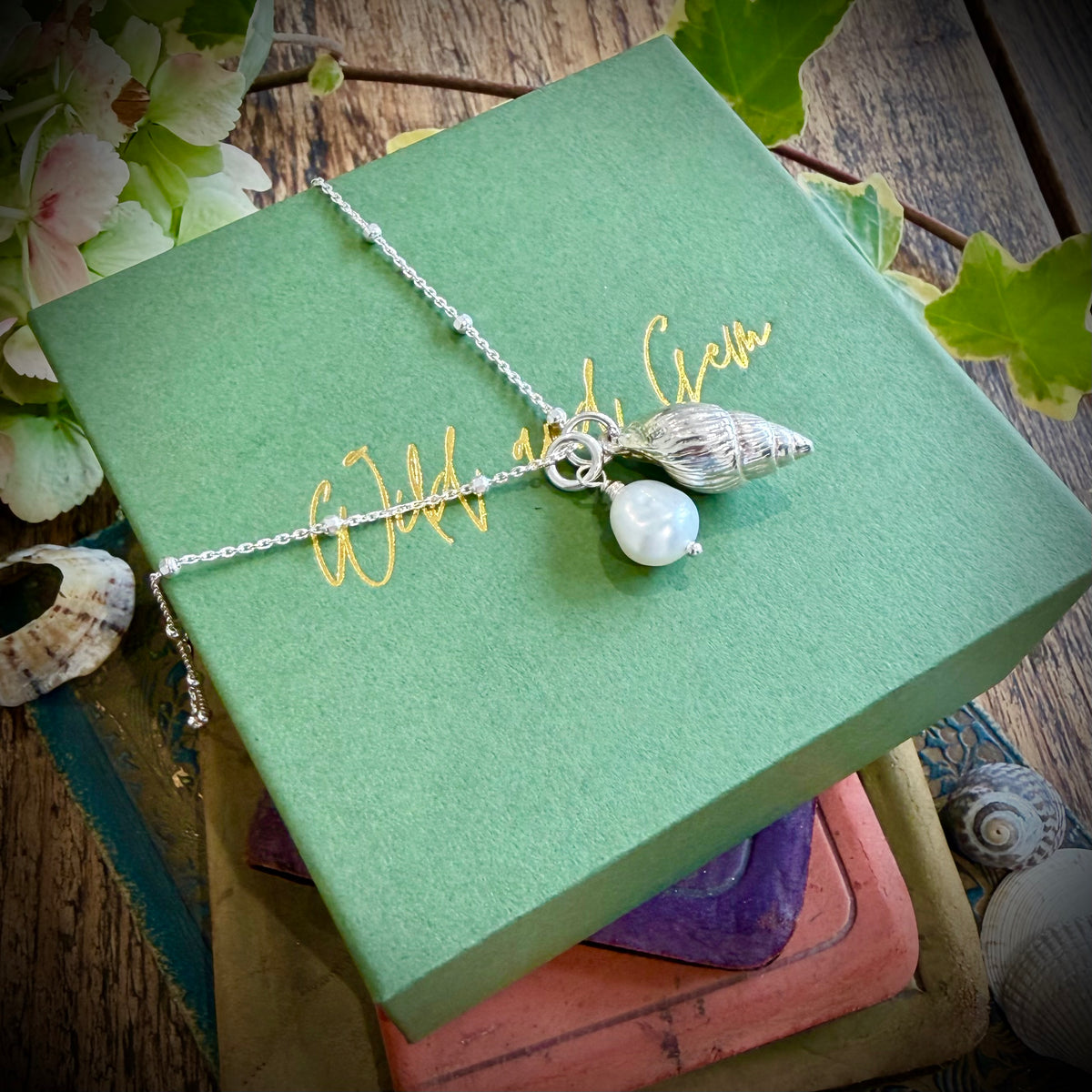 Solid silver whelk shell with keishi pearl