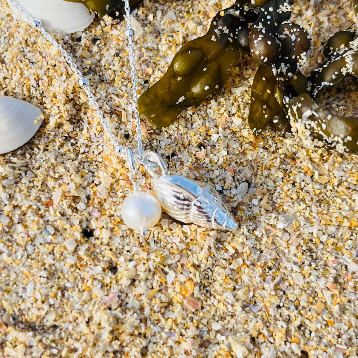 Solid silver whelk shell with keishi pearl