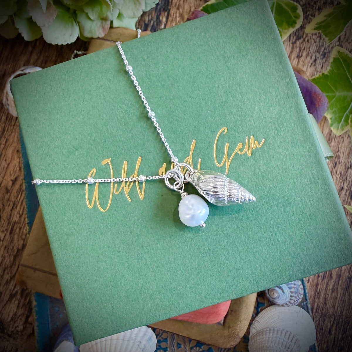 Solid silver whelk shell with keishi pearl